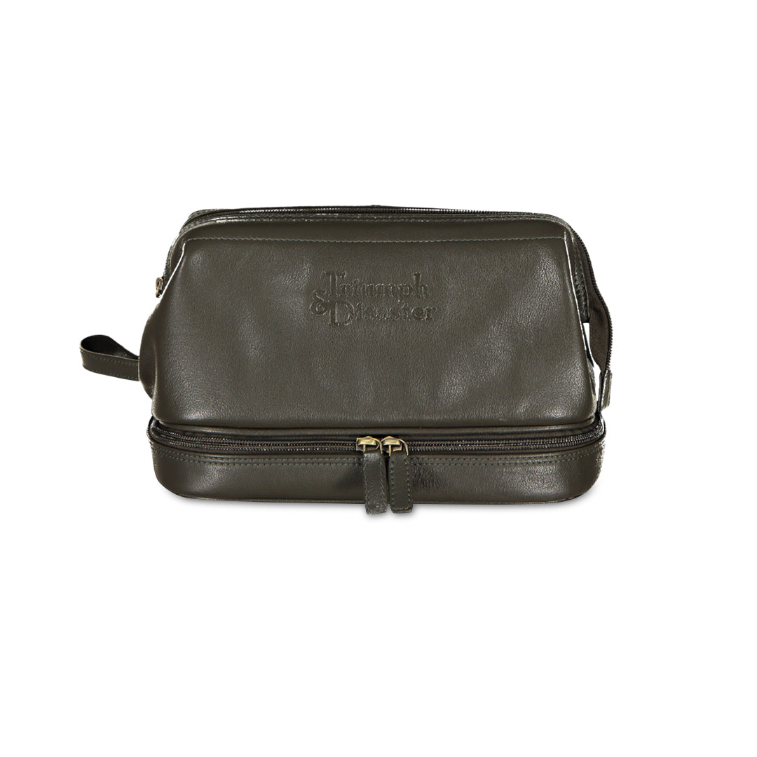 Green leather toiletry bag with gold zipper on a white background